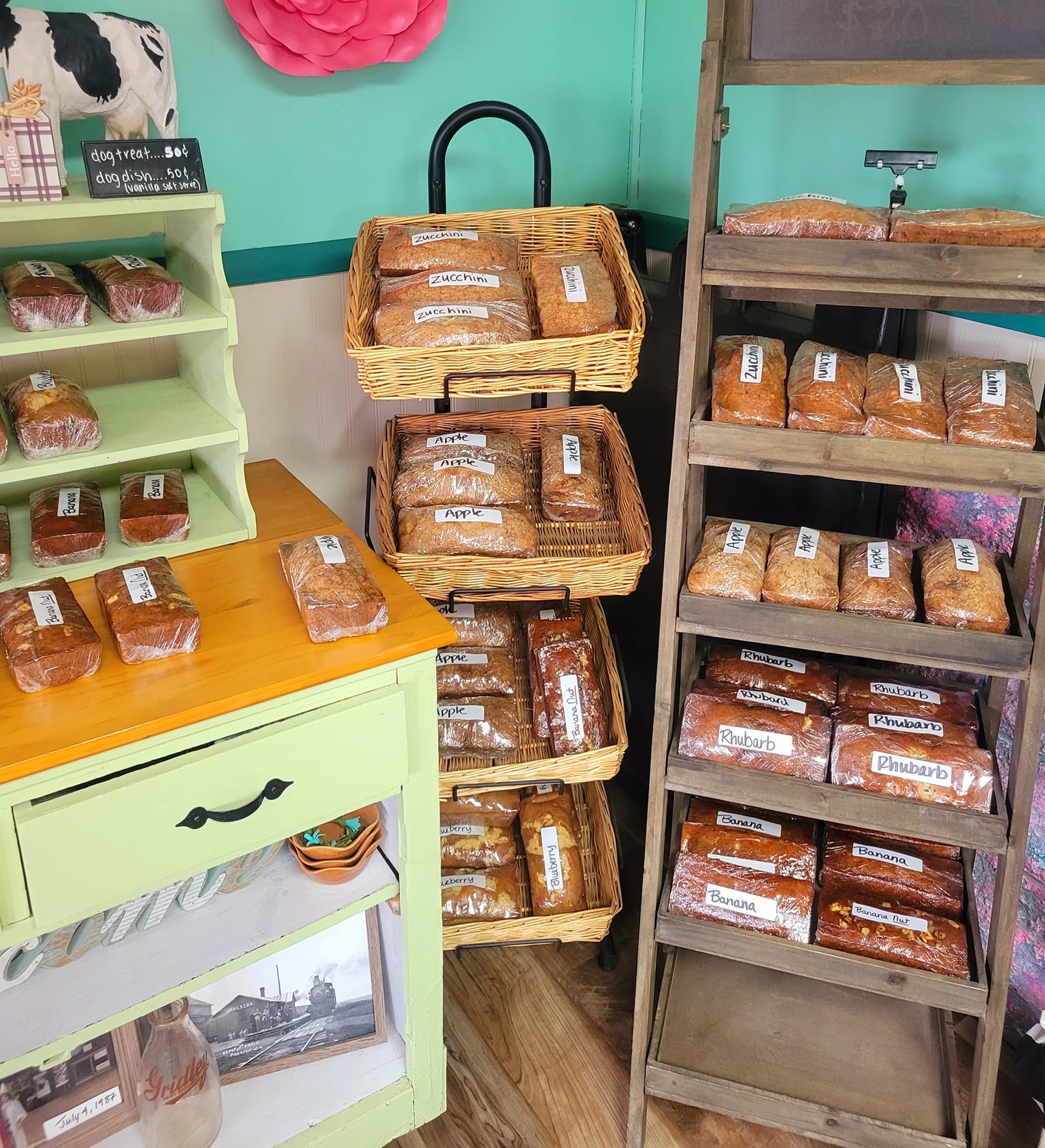Various homemade breads displayed on wooden racks.