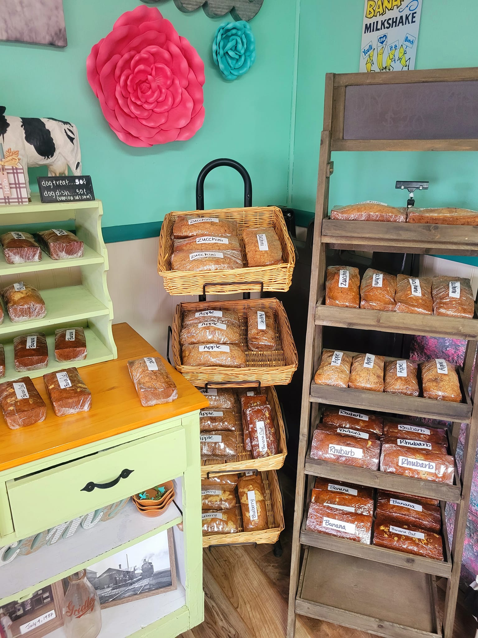 Various homemade breads displayed on wooden racks.